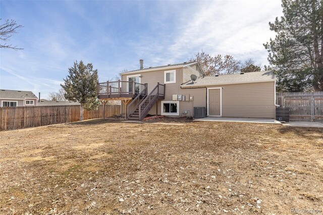 back of house with stairway, a wooden deck, fence private yard, central AC unit, and a patio