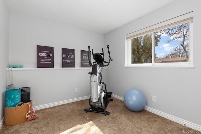 exercise area with baseboards and carpet