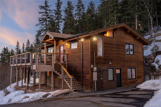 view of front of house with stairs and a wooden deck