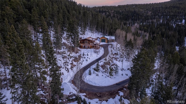 snowy aerial view with a forest view