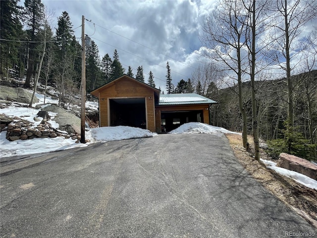 32094 Christopher Ln, Conifer, CO 80433 - snow covered garage featuring a forest view and a detached garage