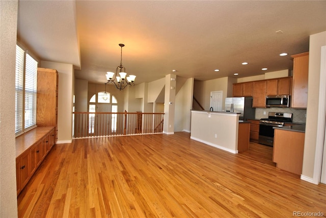 10835 Tincup Creek Pt, Colorado Springs, CO 80908 - unfurnished living room featuring light wood finished floors, healthy amount of natural light, a chandelier, and recessed lighting