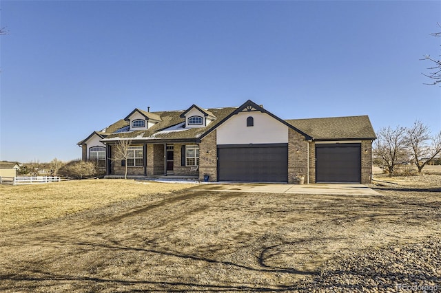 view of front of home with a garage, fence, concrete driveway, and brick siding