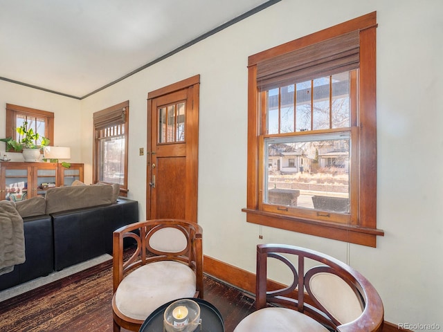 sitting room with dark hardwood / wood-style floors, ornamental molding, and plenty of natural light