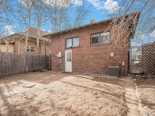 back of property featuring central AC