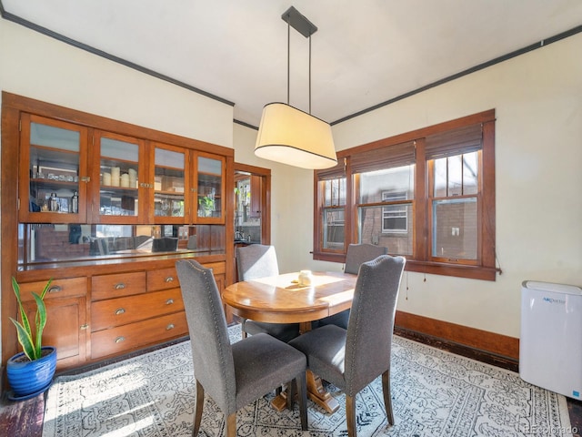 dining space featuring radiator heating unit and crown molding