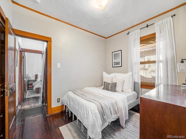 bedroom featuring dark wood-type flooring and crown molding