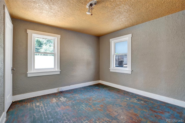 spare room with a textured ceiling