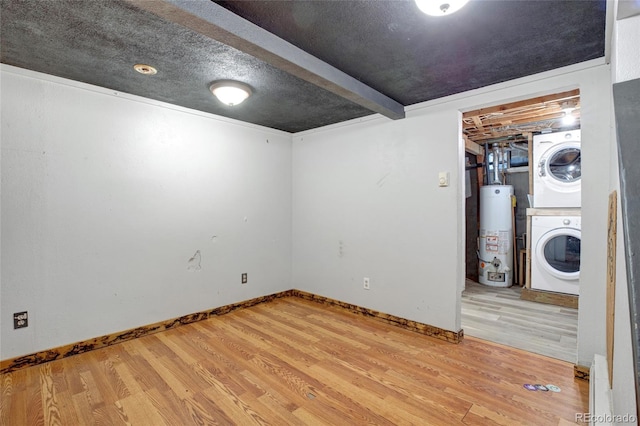 basement with stacked washing maching and dryer, gas water heater, and light hardwood / wood-style floors