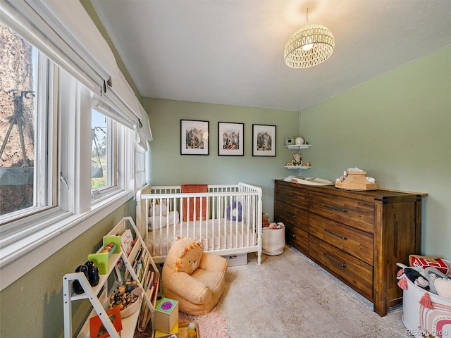 27385 Spruce Ln, Evergreen, CO 80439 - bedroom featuring a crib, carpet flooring, and a chandelier