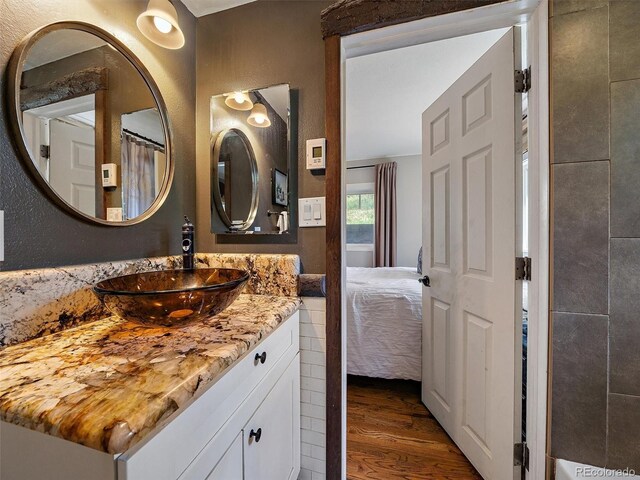 27385 Spruce Ln, Evergreen, CO 80439 - ensuite bathroom with wood finished floors and vanity