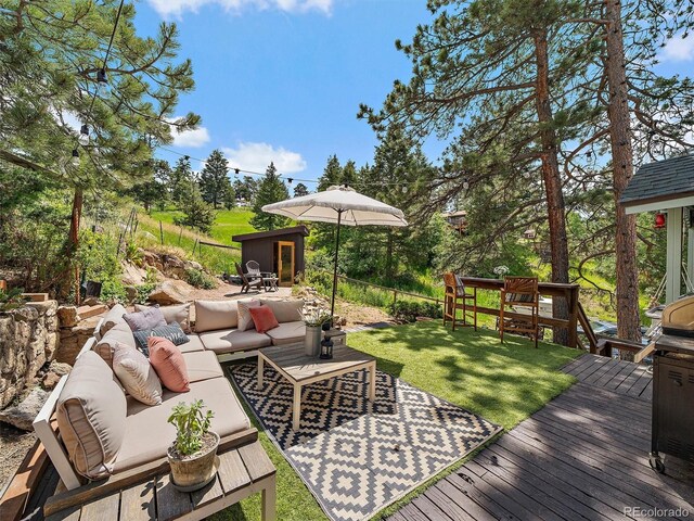 27385 Spruce Ln, Evergreen, CO 80439 - wooden deck with outdoor lounge area, a yard, and view of scattered trees