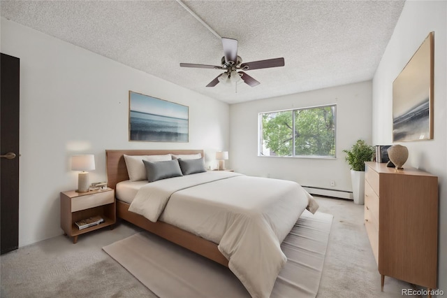 bedroom with light carpet, ceiling fan, baseboard heating, and a textured ceiling