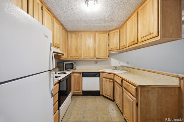 kitchen featuring light brown cabinets, light tile patterned flooring, sink, white appliances, and a textured ceiling