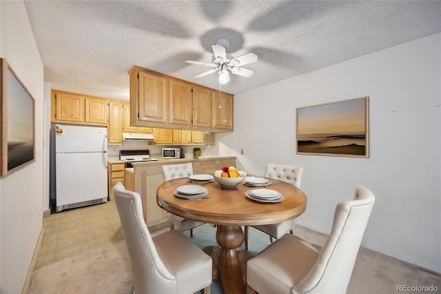 dining room with a textured ceiling and ceiling fan