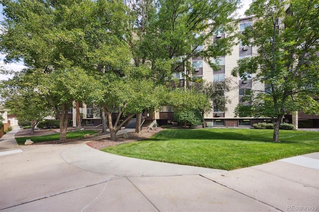 view of property's community with a lawn