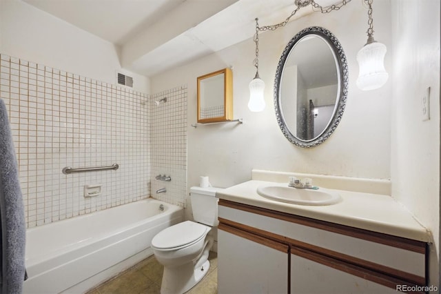 full bathroom with tile patterned floors, tiled shower / bath combo, vanity, and toilet