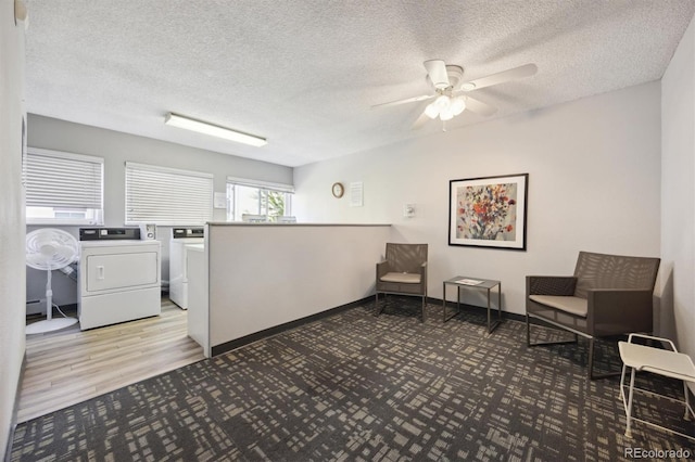 interior space with light hardwood / wood-style floors, ceiling fan, independent washer and dryer, and a textured ceiling