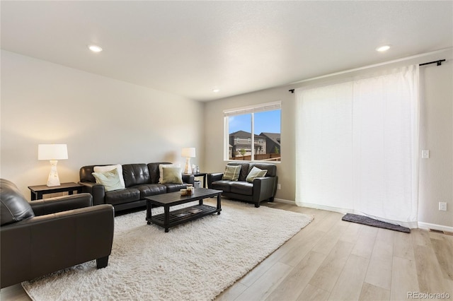 6150 Sugarloaf St, Brighton, CO 80601 - living area with light wood-type flooring and recessed lighting