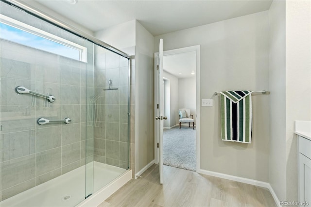 6150 Sugarloaf St, Brighton, CO 80601 - full bathroom featuring a shower stall, wood finished floors, and vanity