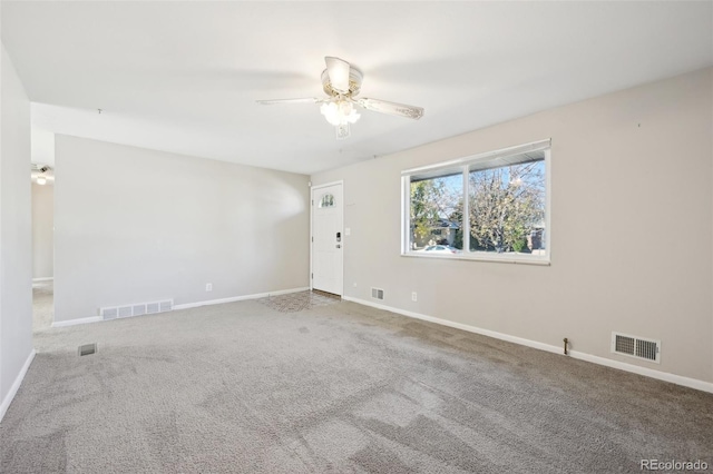 carpeted empty room featuring ceiling fan