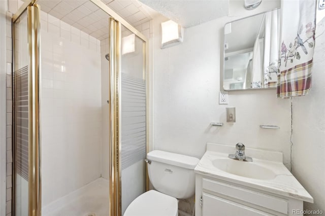 bathroom with toilet, vanity, and walk in shower