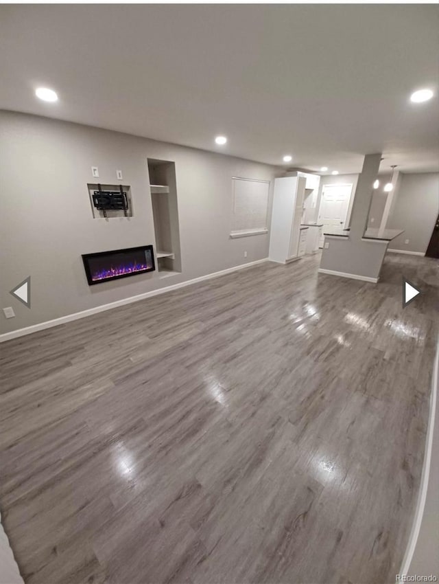 unfurnished living room with wood-type flooring