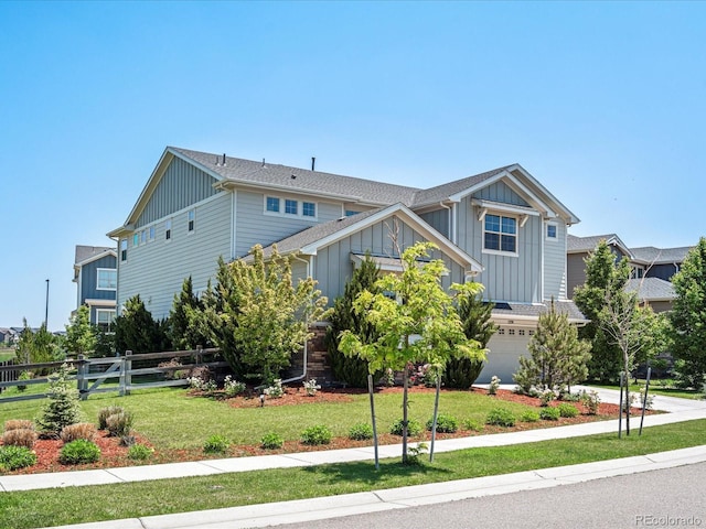 1291 Fountain Ln, Erie, CO 80516 - view of front facade featuring board and batten siding, a garage, and concrete driveway