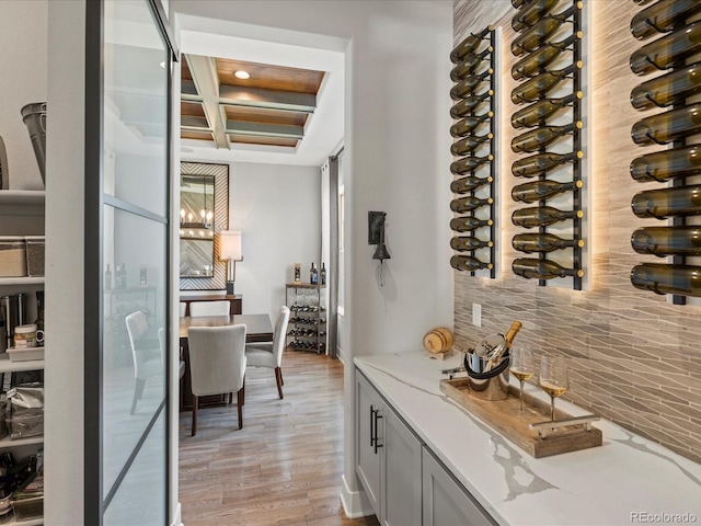 1291 Fountain Ln, Erie, CO 80516 - wine cellar featuring light wood finished floors, coffered ceiling, and beam ceiling