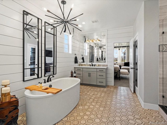 1291 Fountain Ln, Erie, CO 80516 - bathroom featuring healthy amount of natural light, a freestanding tub, vanity, and a stall shower
