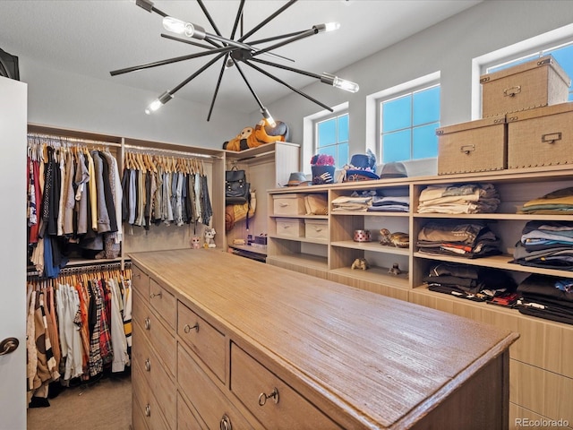 1291 Fountain Ln, Erie, CO 80516 - walk in closet featuring carpet floors and a chandelier