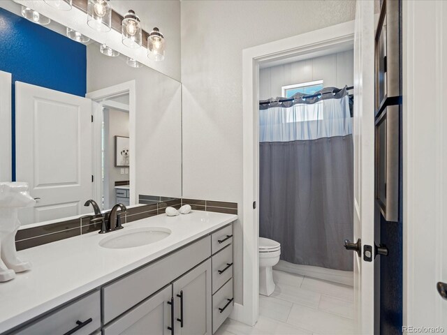 1291 Fountain Ln, Erie, CO 80516 - bathroom featuring vanity, shower / bathtub combination with curtain, and marble finish floors