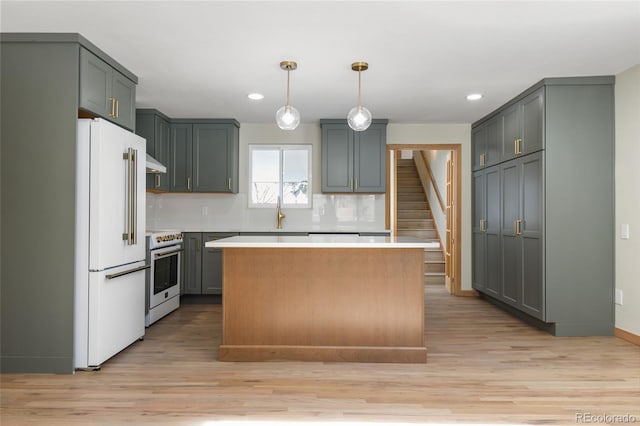 kitchen with gray cabinetry, white appliances, and a center island