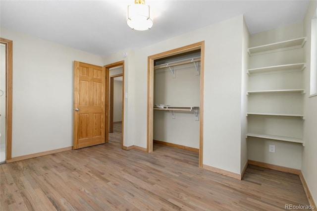 unfurnished bedroom featuring light hardwood / wood-style floors and a closet