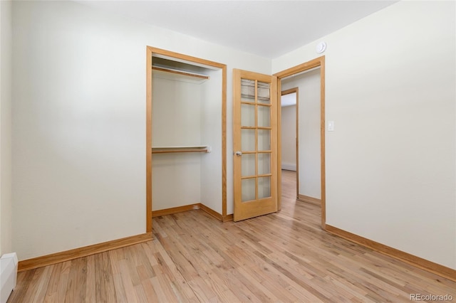 unfurnished bedroom with a closet and light hardwood / wood-style flooring