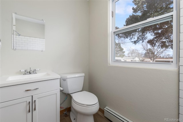 bathroom with baseboard heating, vanity, and toilet