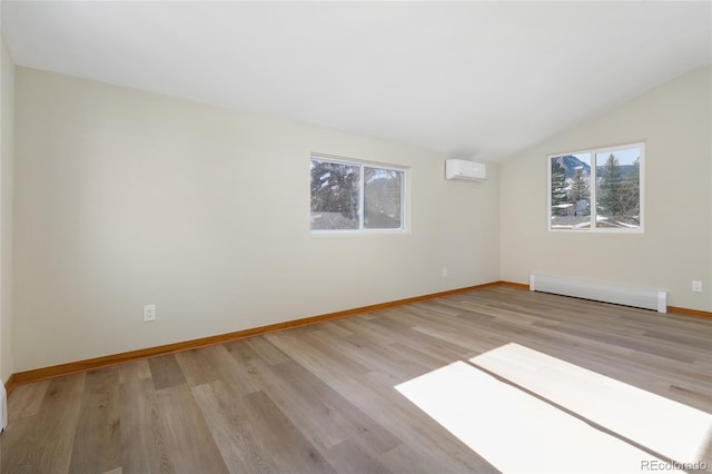 empty room with a healthy amount of sunlight, a baseboard heating unit, a wall mounted AC, and light hardwood / wood-style floors