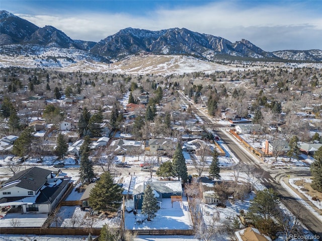 snowy aerial view with a mountain view