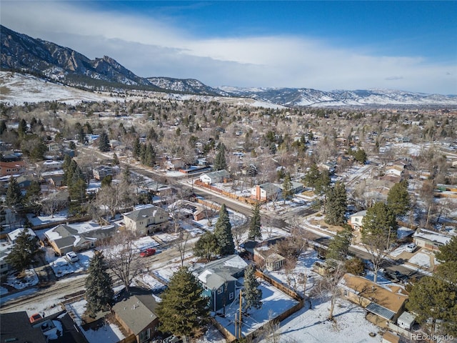 snowy aerial view featuring a mountain view