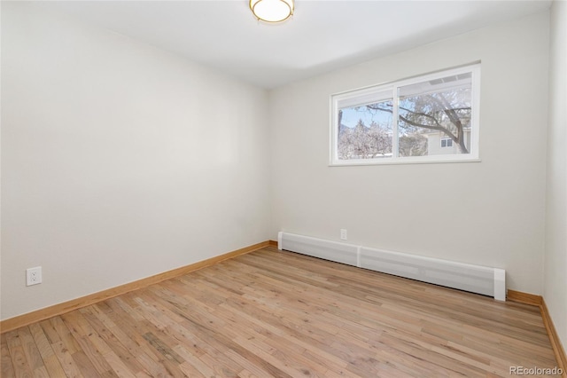 unfurnished room featuring light wood-type flooring, baseboards, and baseboard heating