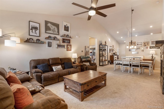 carpeted living room featuring high vaulted ceiling and ceiling fan