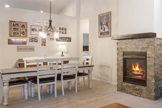 carpeted dining space featuring a fireplace