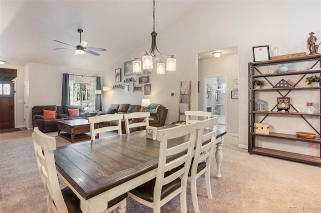 dining area with light carpet, high vaulted ceiling, and a healthy amount of sunlight