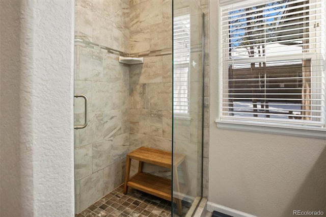 bathroom with a shower with shower door