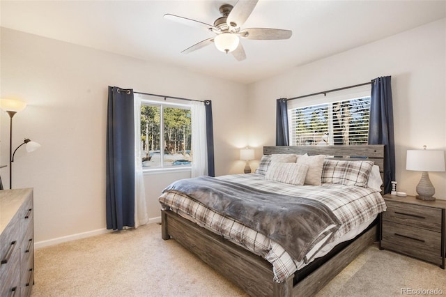 1323 Firestone Dr, Woodland Park, CO 80863 - bedroom with multiple windows, baseboards, light colored carpet, and a ceiling fan