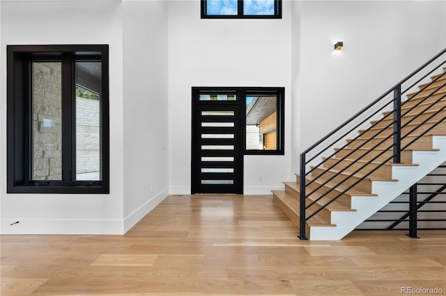8077 Raphael Ln, Littleton, CO 80125 - entrance foyer featuring wood finished floors and stairs