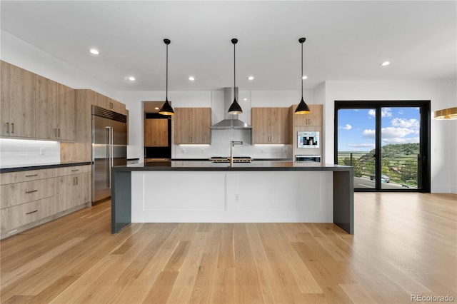 8077 Raphael Ln, Littleton, CO 80125 - kitchen featuring wall chimney range hood, built in refrigerator, modern cabinets, dark countertops, and backsplash