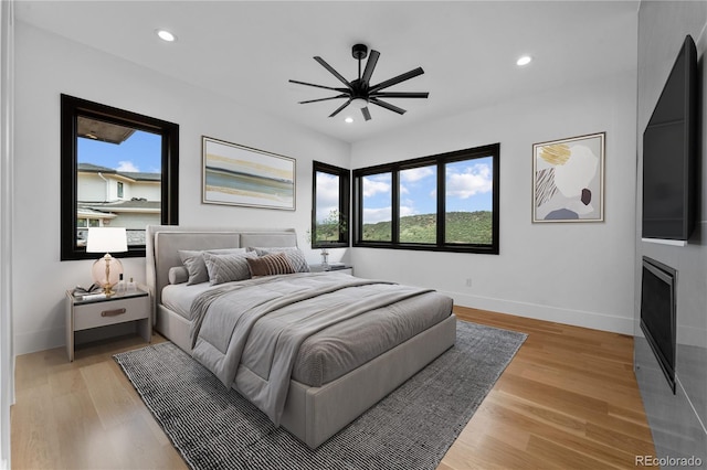 8077 Raphael Ln, Littleton, CO 80125 - bedroom with multiple windows, recessed lighting, light wood-style floors, and ceiling fan
