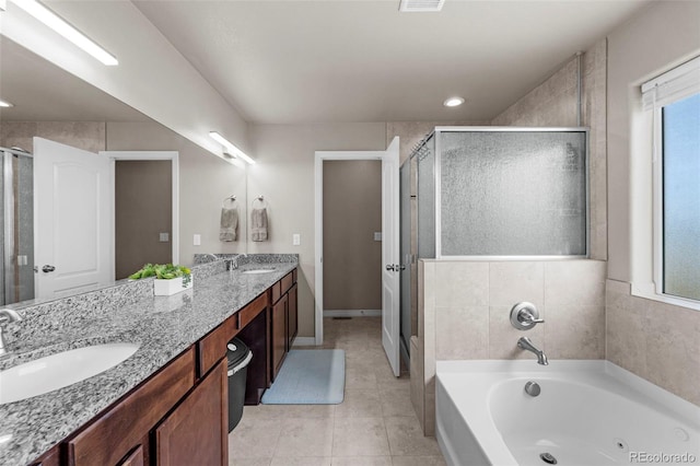 full bath with a stall shower, double vanity, a garden tub, and a sink