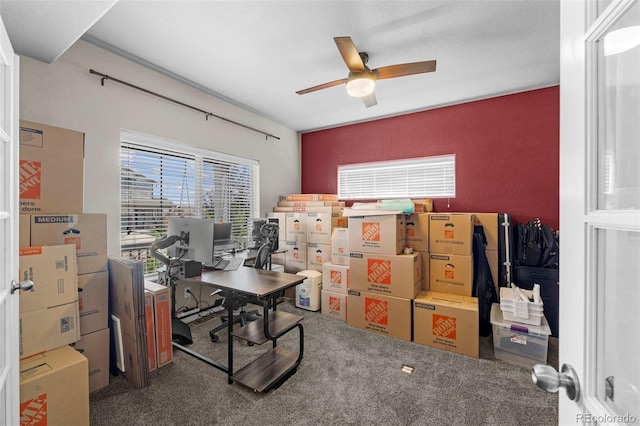 carpeted home office featuring ceiling fan